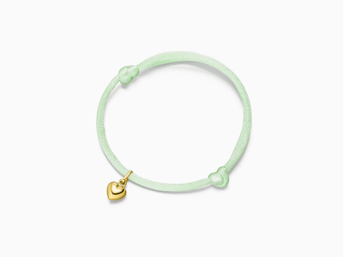 Heart pendant on silk bracelet